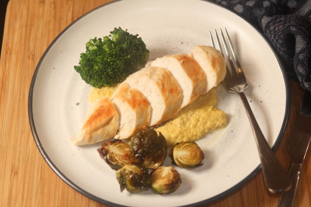 Dairy free macadamia cream served with sliced chicken breast, broccoli and pan fried Brussels sprouts