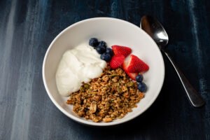 peanut butter granola with fresh berries and yoghurt
